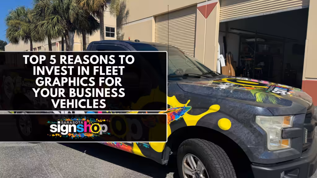 A black pickup truck with colorful graphics parked outside a building. Overlaid text reads: Top 5 Reasons to Invest in Fleet Graphics for Your Business Vehicles. Sarasota Sign Shop logo appears at the bottom.
