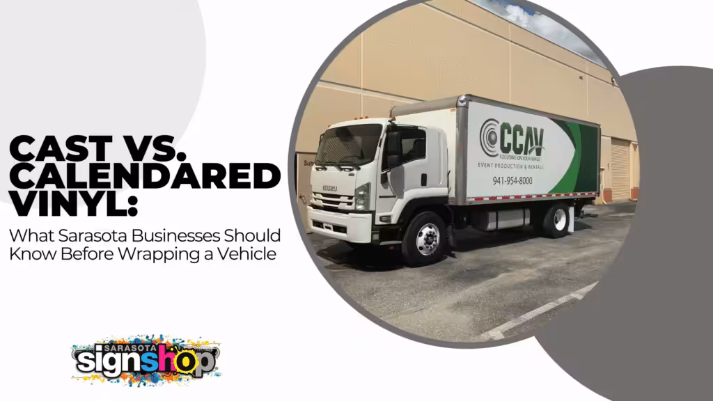 A white box truck with a green and gray company logo is parked beside a tan building. Text reads Cast vs. Calendered Vinyl: What Sarasota Businesses Should Know Before Wrapping a Vehicle.