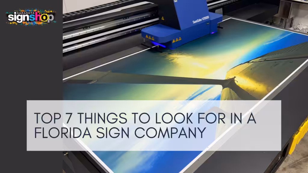 A large printer produces a vibrant sunset image. In the corner, a Sarasota Sign Shop logo appears. Overlaid text reads, Top 7 things to look for in a Florida sign company.