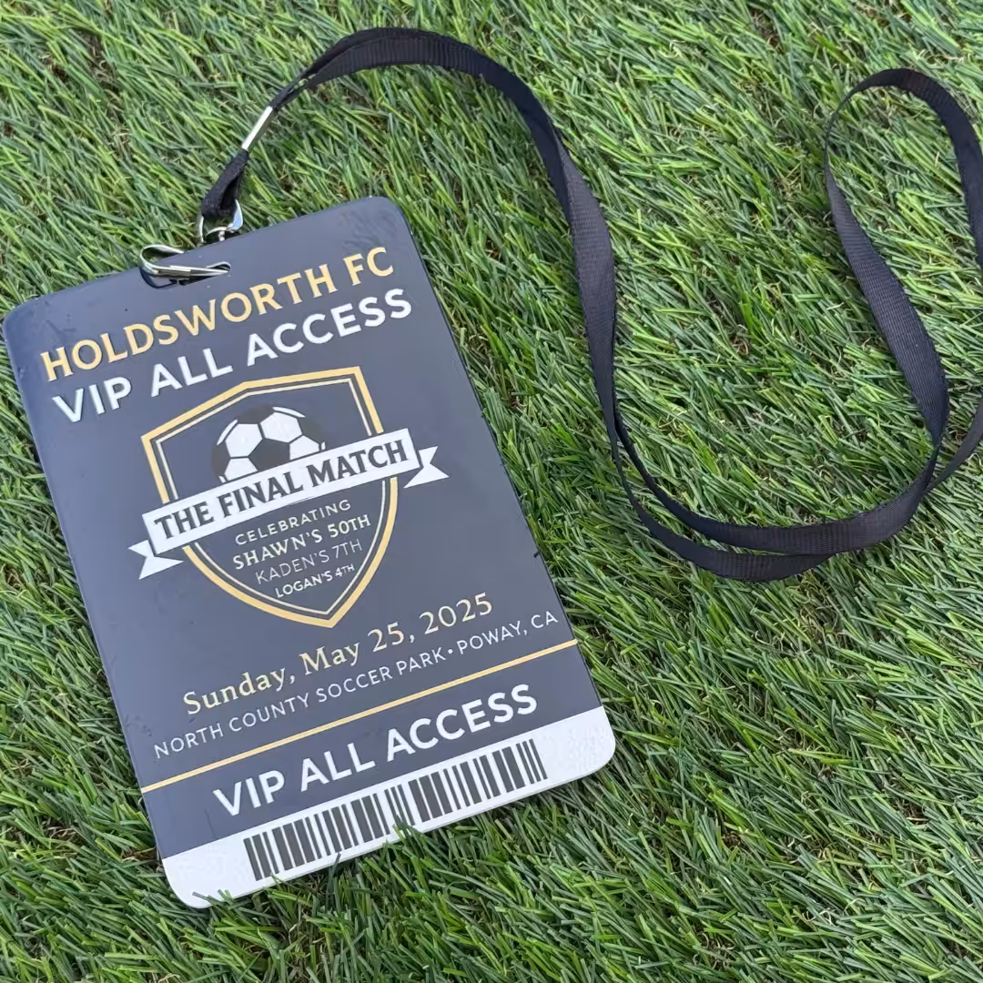 A black VIP pass lanyard for Holdsworth FC’s final match lies on green turf, highlighting Schools & Sports at North County Soccer Park, Poway, CA, on May 25, 2025. The badge shows a soccer ball graphic and gold text.